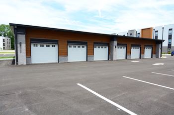 a row of garage doors in a parking lot